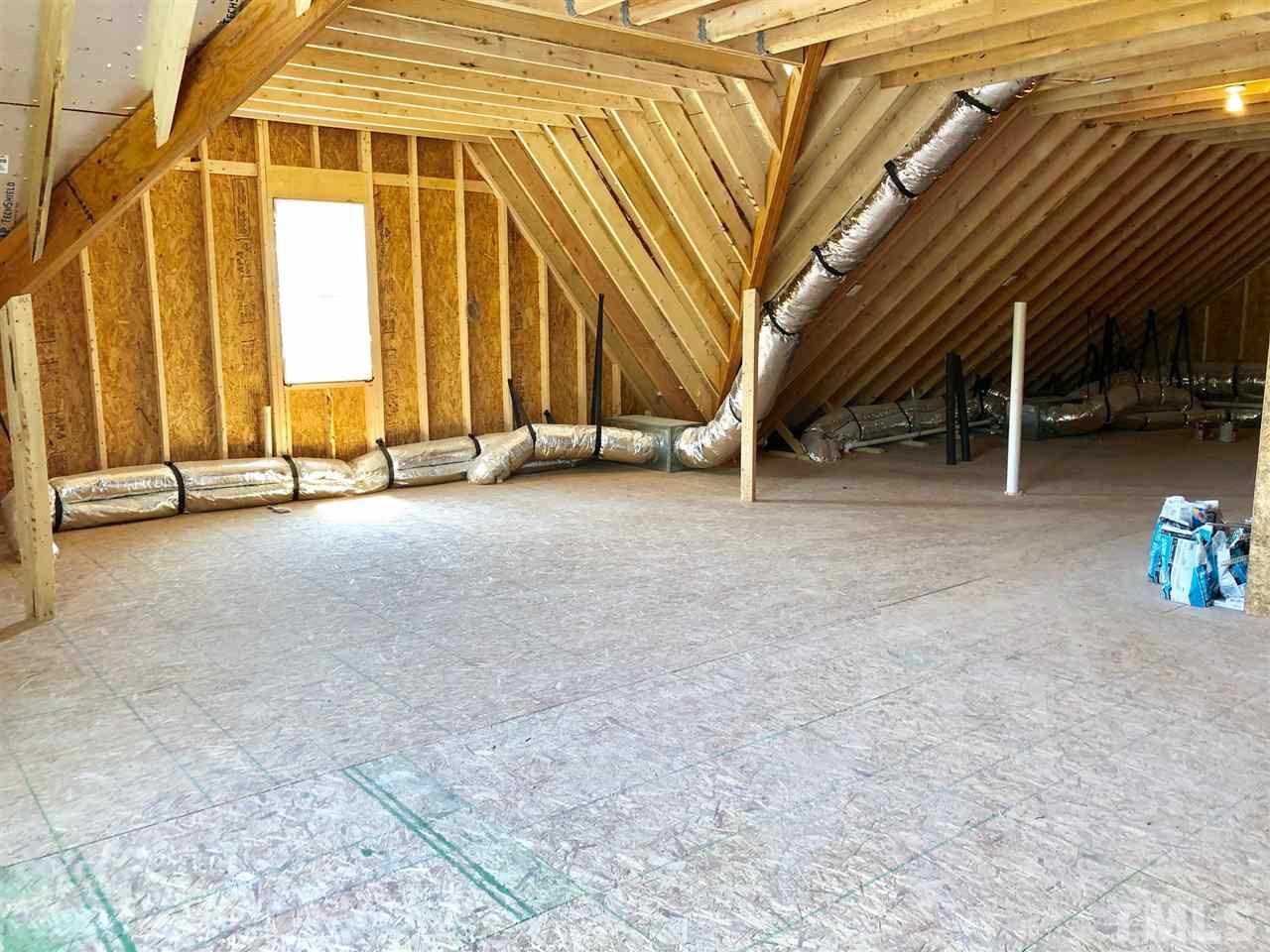 112 Roseroot Court Holly Springs, NC 27540 - Photo 16 of 30 a view of an empty room with a staircase