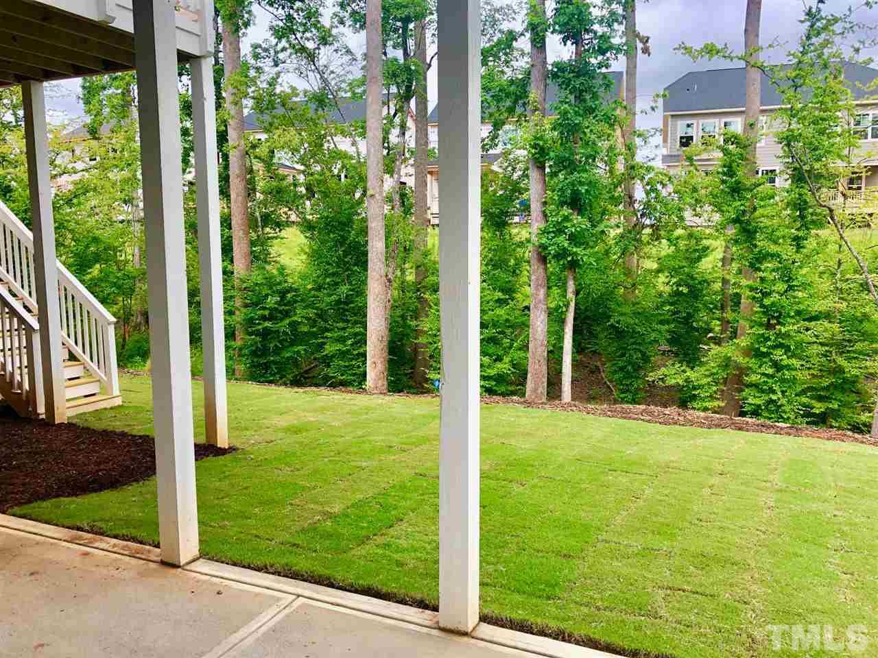 112 Roseroot Court Holly Springs, NC 27540 - Photo 18 of 30 a view of a backyard with garden
