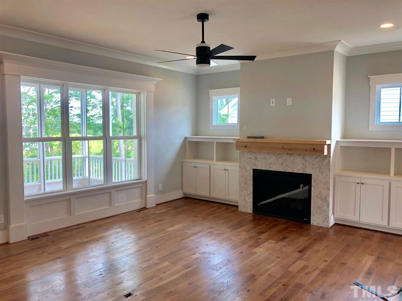 112 Roseroot Court Holly Springs, NC 27540 - Photo 4 of 30 a view of an empty room with window and fire place