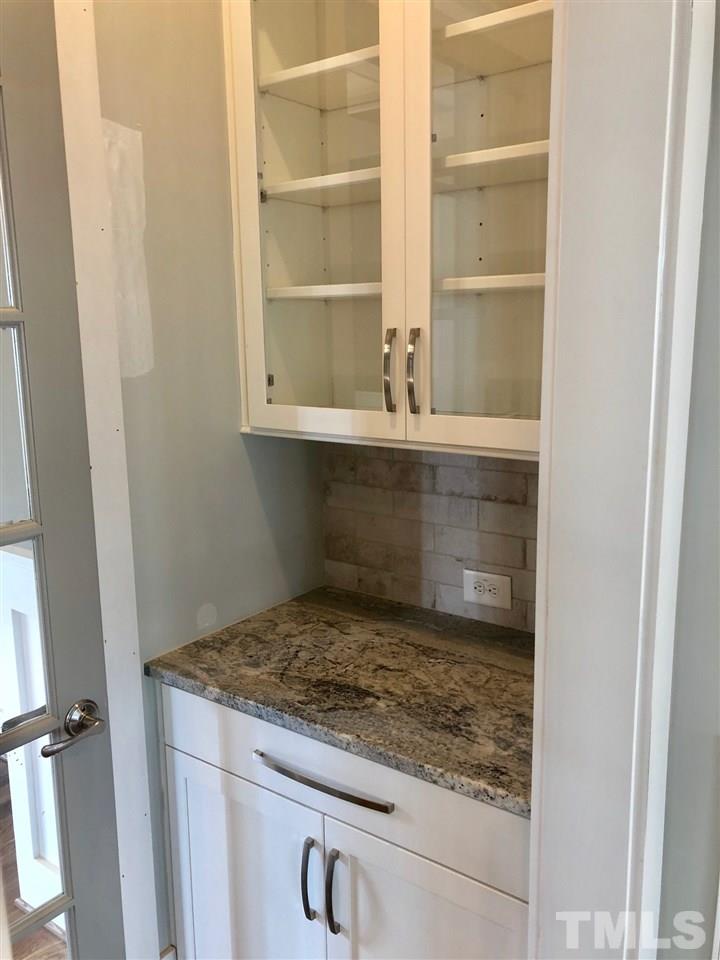 112 Roseroot Court Holly Springs, NC 27540 - Photo 5 of 30 a bathroom with a granite countertop sink and a window