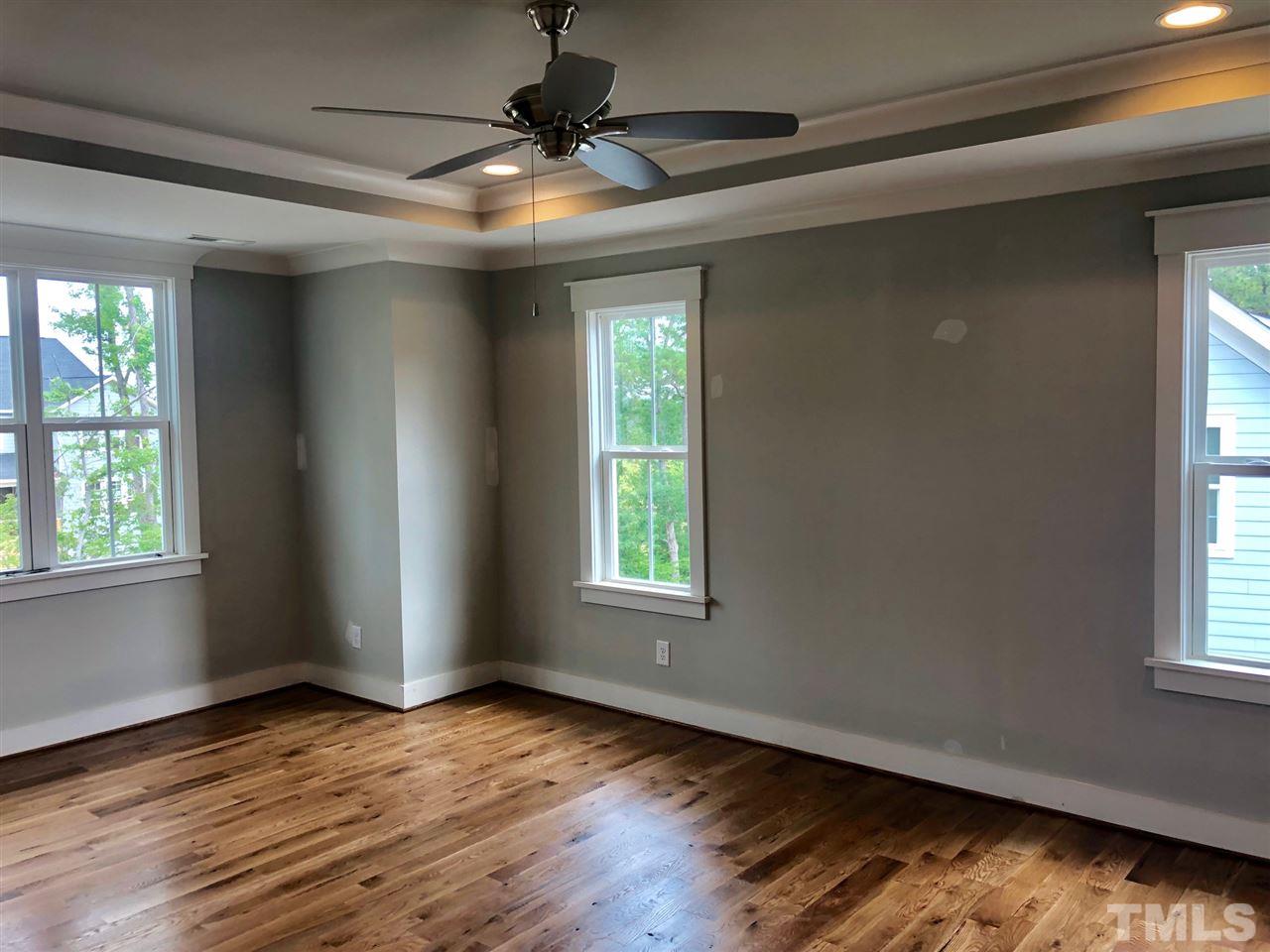 112 Roseroot Court Holly Springs, NC 27540 - Photo 6 of 30 an empty room with wooden floor and windows