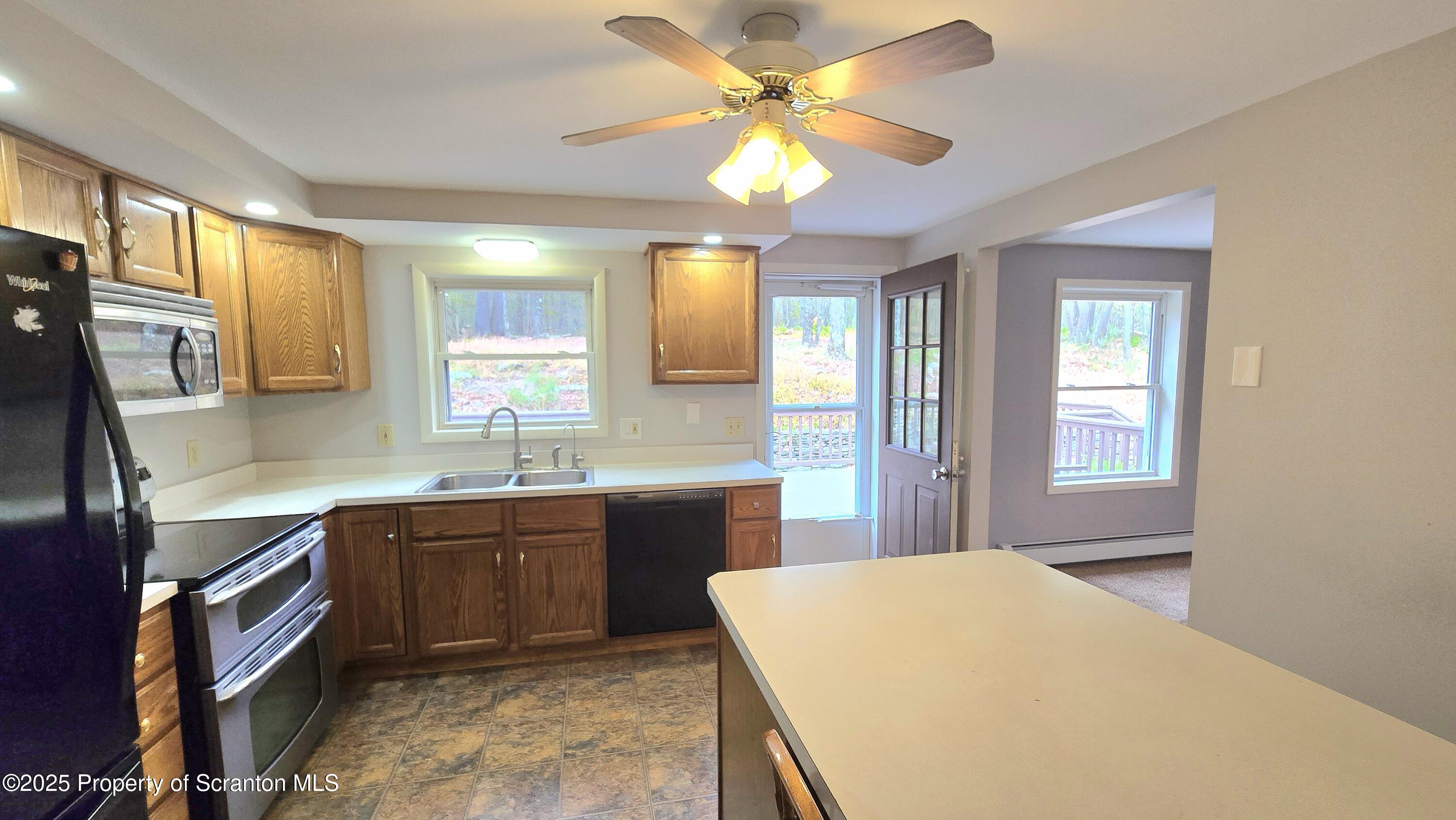 2311 Motichka Road Moscow, PA 18444 - Photo 11 of 89 a kitchen with a table chairs sink and cabinets