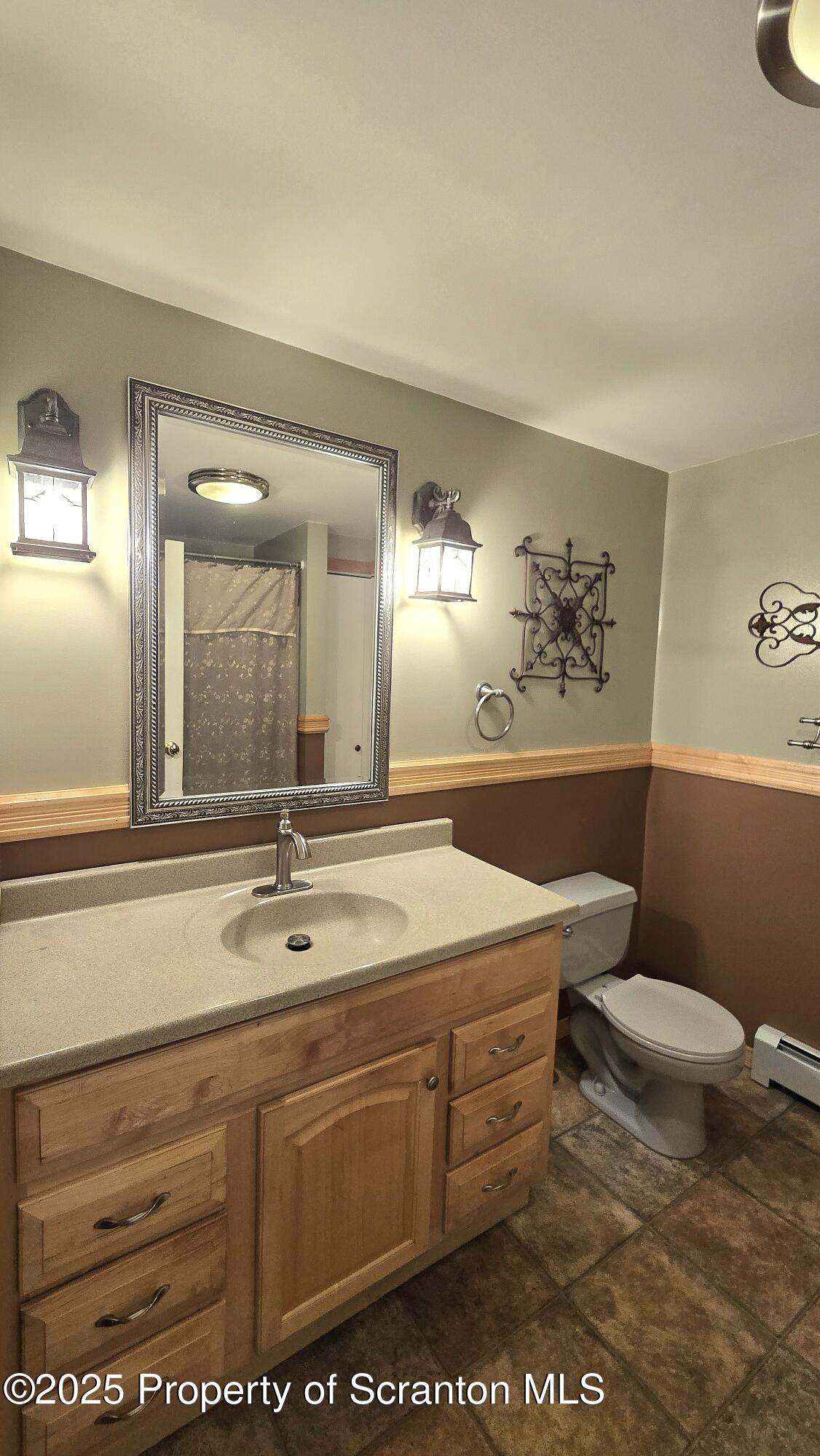 2311 Motichka Road Moscow, PA 18444 - Photo 15 of 89 a bathroom with a granite countertop sink a mirror and a toilet