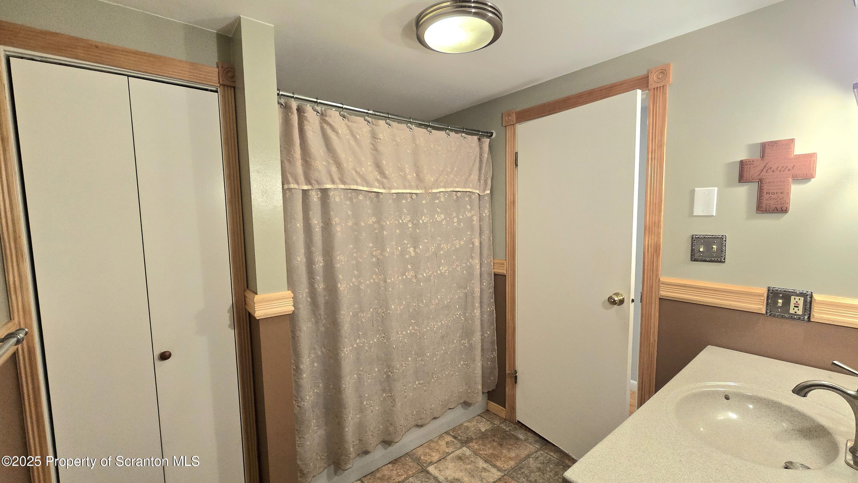 2311 Motichka Road Moscow, PA 18444 - Photo 16 of 89 a bathroom with a sink and a mirror