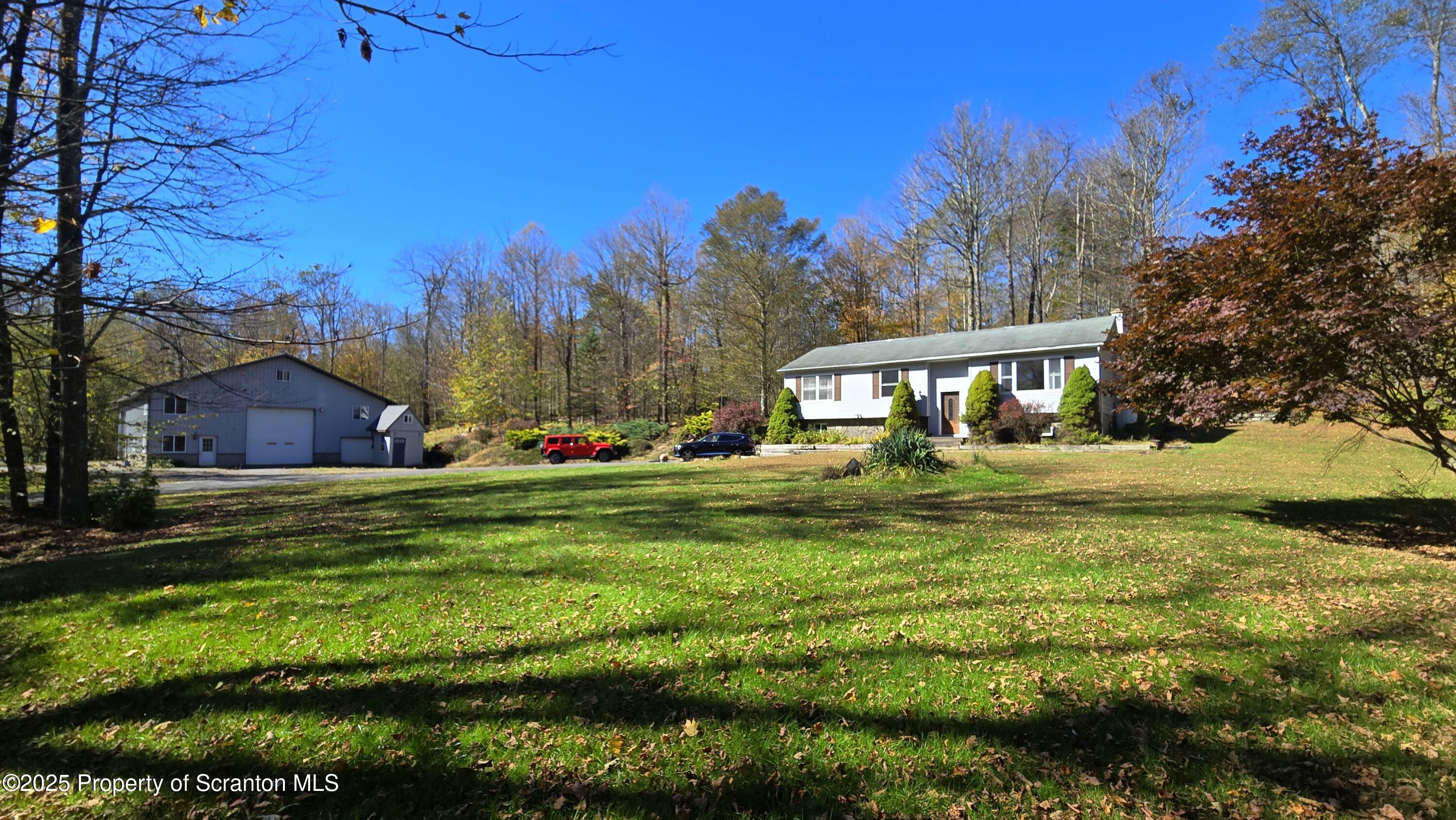2311 Motichka Road Moscow, PA 18444 - Photo 3 of 89 a front view of a house with a yard