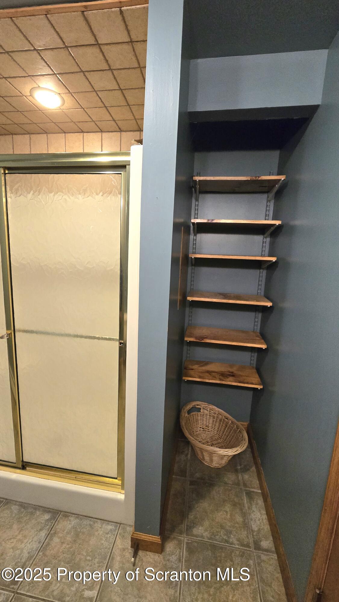 2311 Motichka Road Moscow, PA 18444 - Photo 32 of 89 a view of water heater room with a door and wooden floor