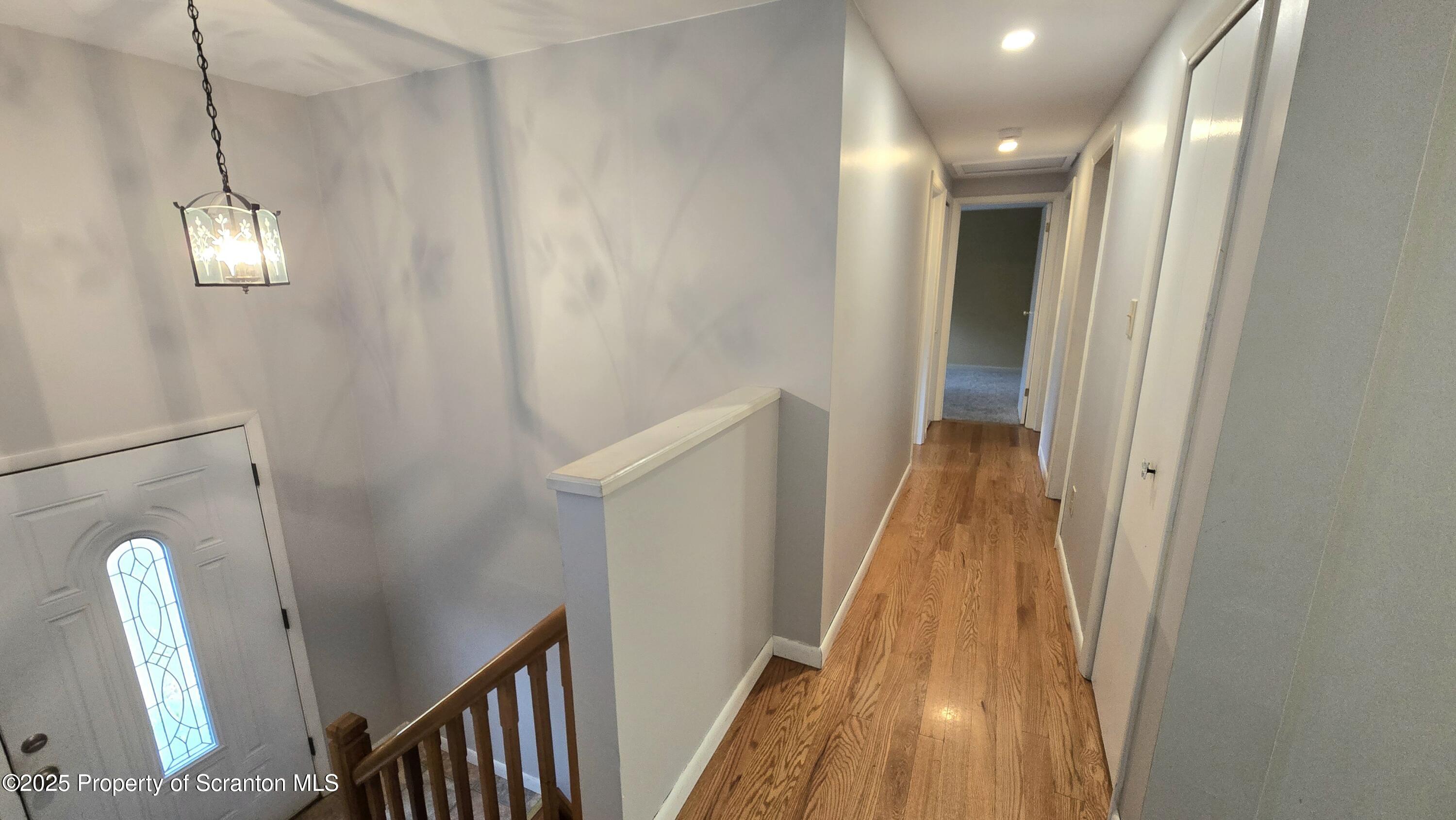 2311 Motichka Road Moscow, PA 18444 - Photo 4 of 89 a view of a hallway with wooden floor and stairs