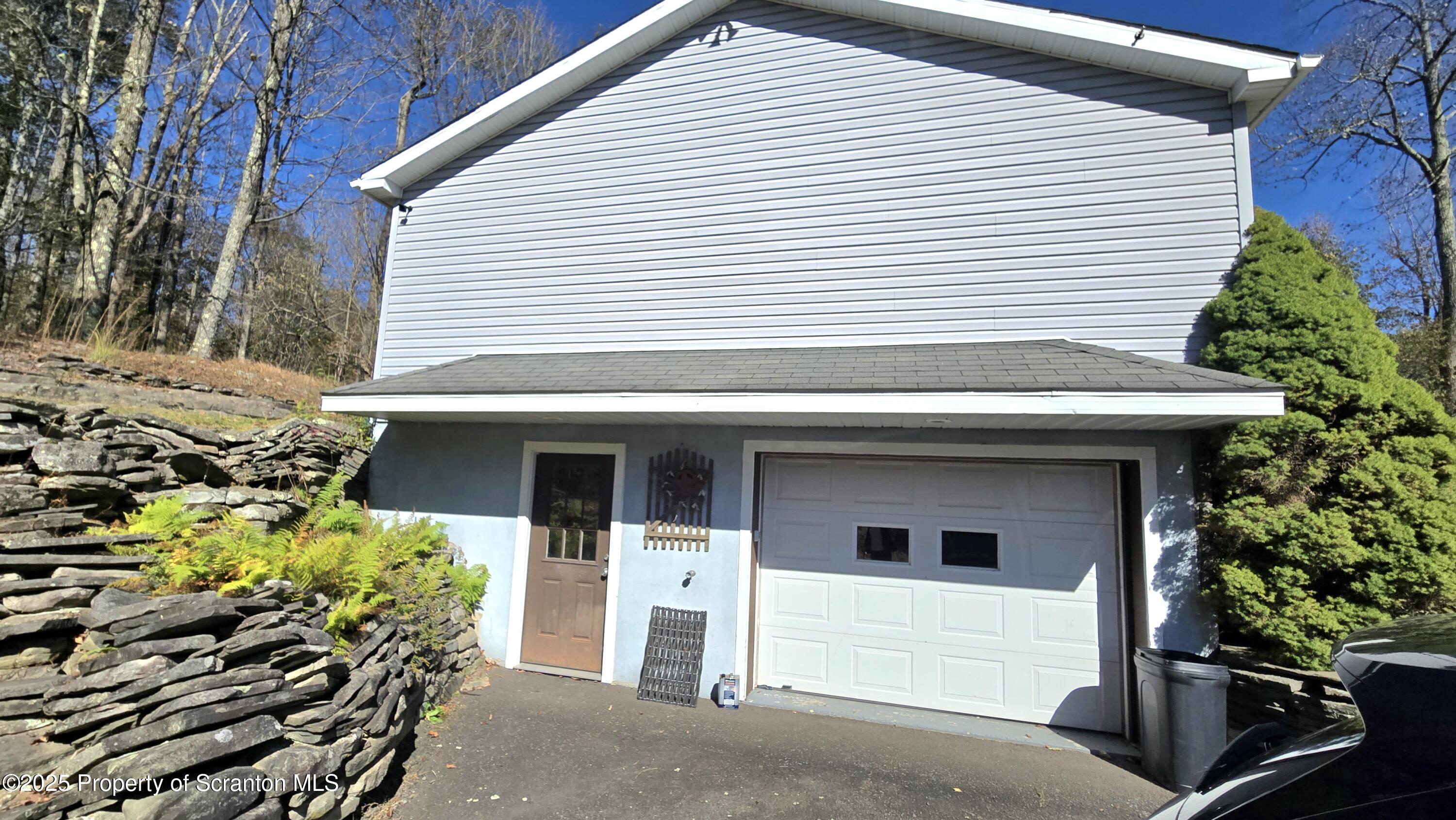 2311 Motichka Road Moscow, PA 18444 - Photo 41 of 89 a front view of a house with a garage