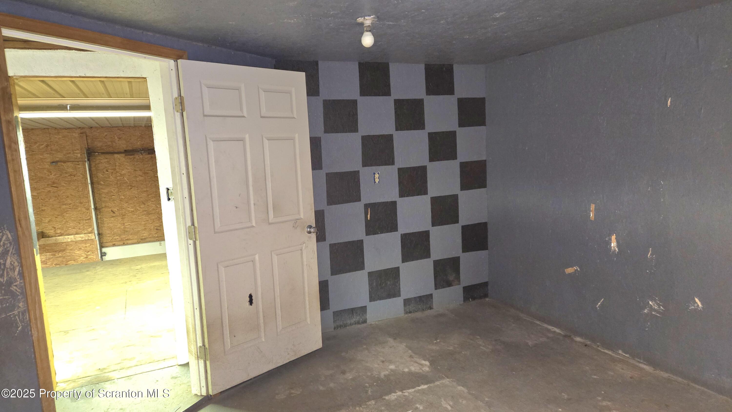 2311 Motichka Road Moscow, PA 18444 - Photo 64 of 89 a view of a bathroom with a black and white checkered floor