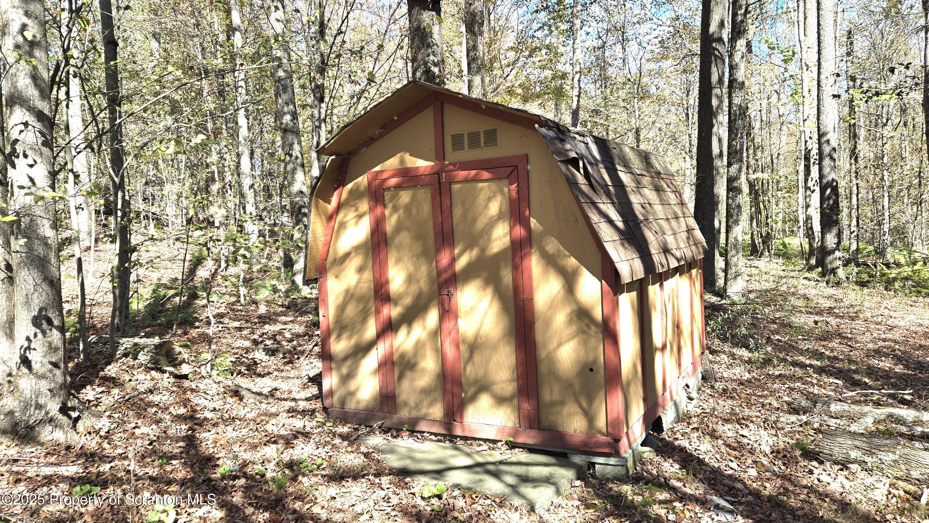 2311 Motichka Road Moscow, PA 18444 - Photo 88 of 89 a view of a wooden house with a large tree
