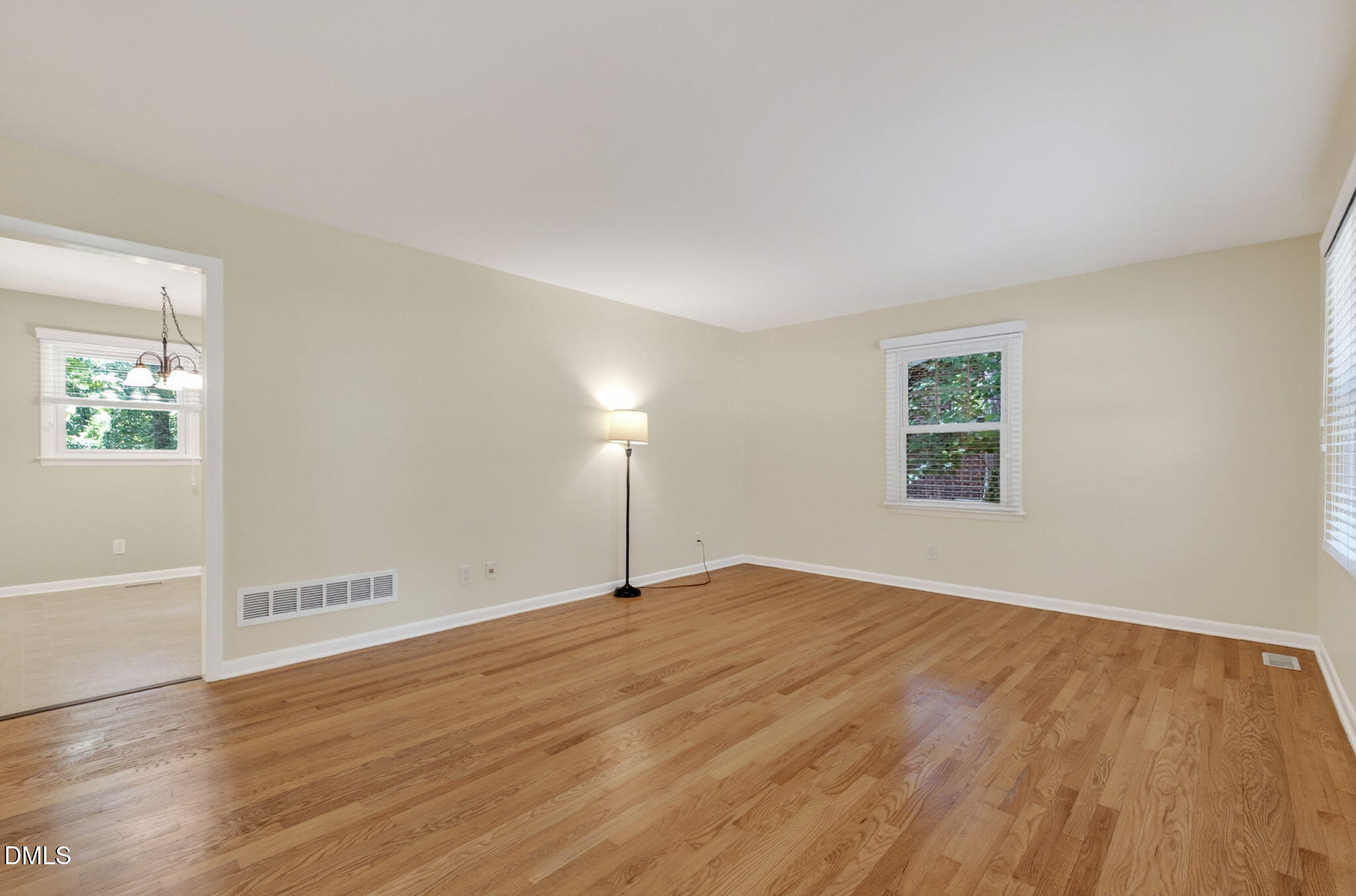 1224 Pineview Drive Raleigh, NC 27606 - Photo 9 of 45 an empty room with wooden floor and windows