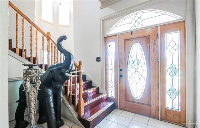 a view of an entryway with wooden floor and door