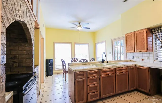a spacious bathroom with a granite countertop sink a large mirror and a shower