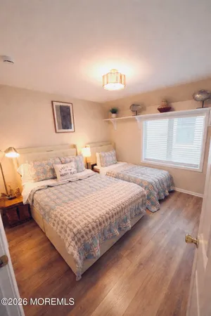 a bedroom with a bed and a night stand