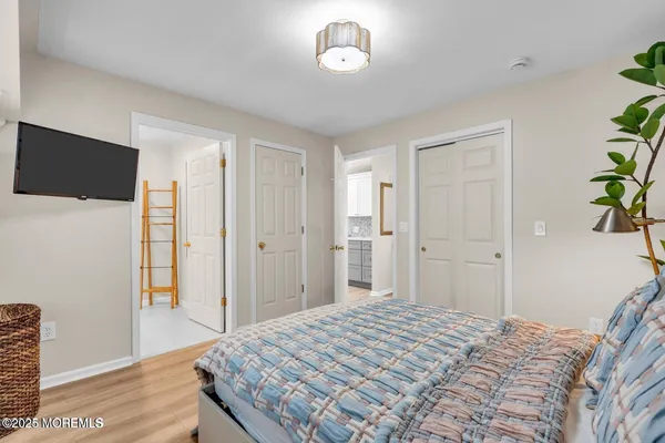 a bedroom with a bed and a chandelier