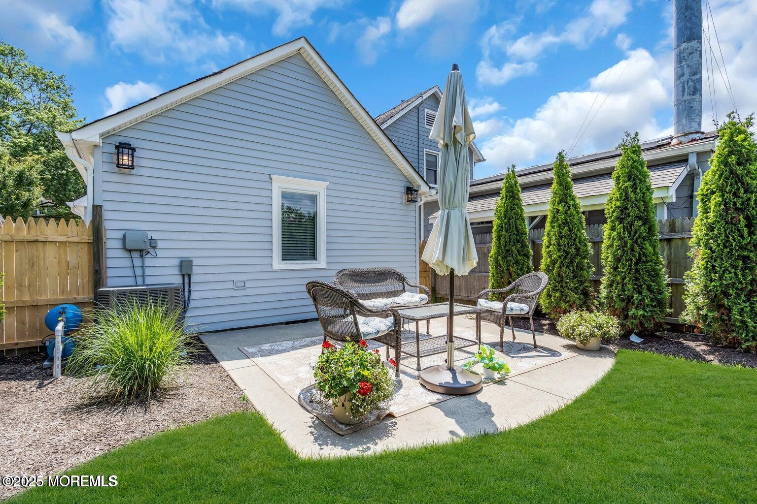 520 Brighton Avenue Spring Lake, NJ 07762 - Photo 21 of 25 a view of a patio with table and chairs potted plants and floor to ceiling window