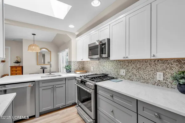 a kitchen with a sink stove and microwave