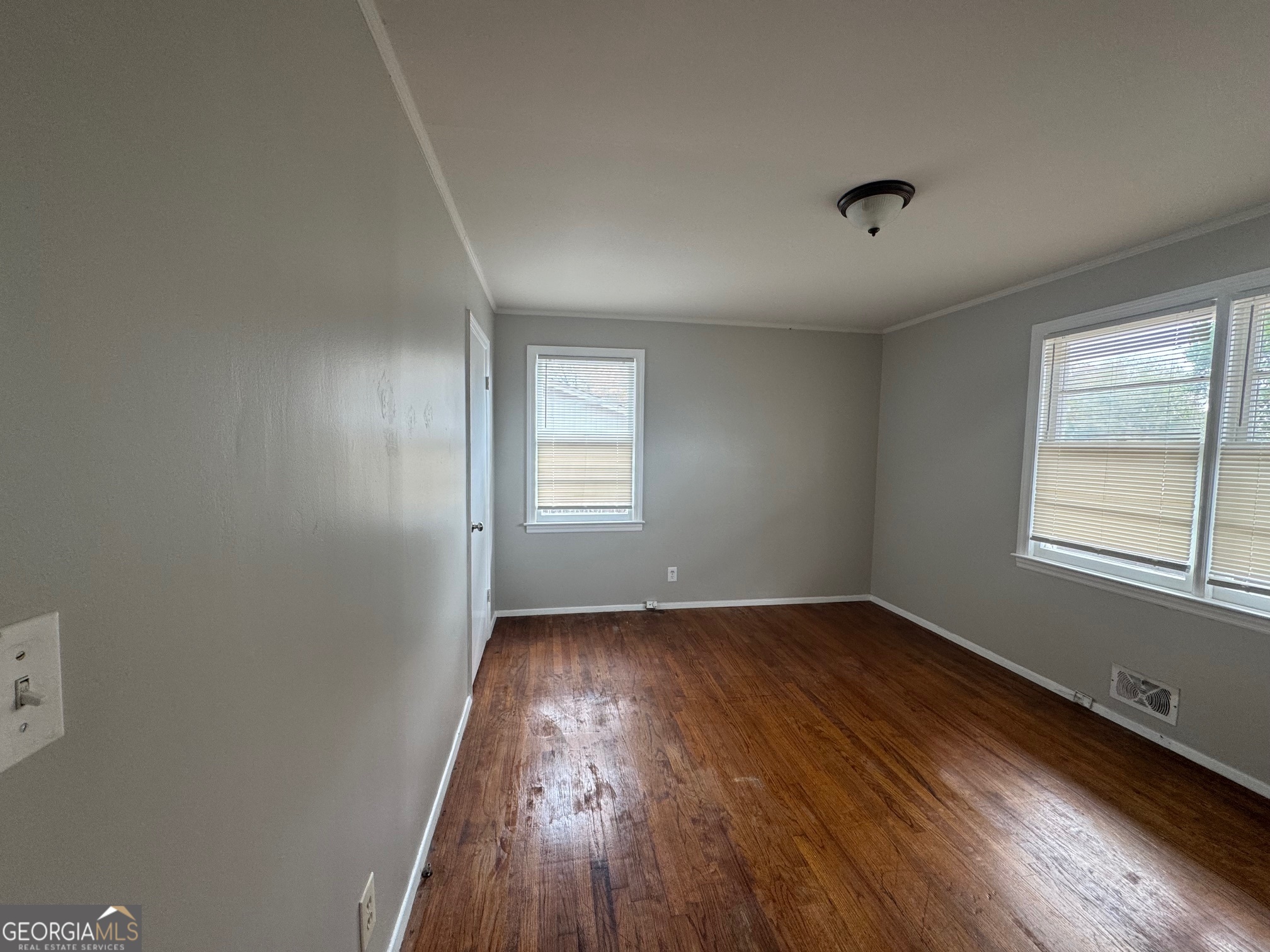 3515 Greenbriar Road Macon, GA 31204 - Photo 11 of 22 an empty room with wooden floor and windows