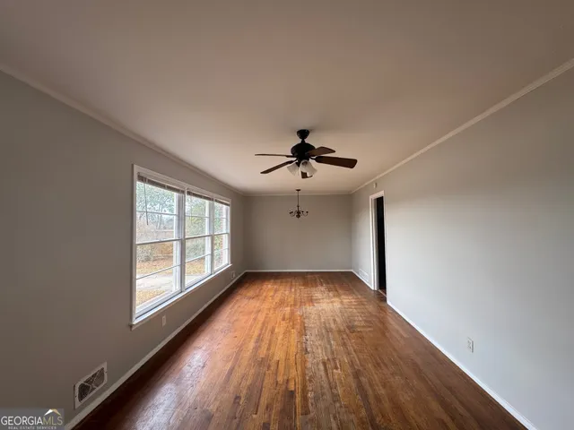 wooden floor in an empty room with a window