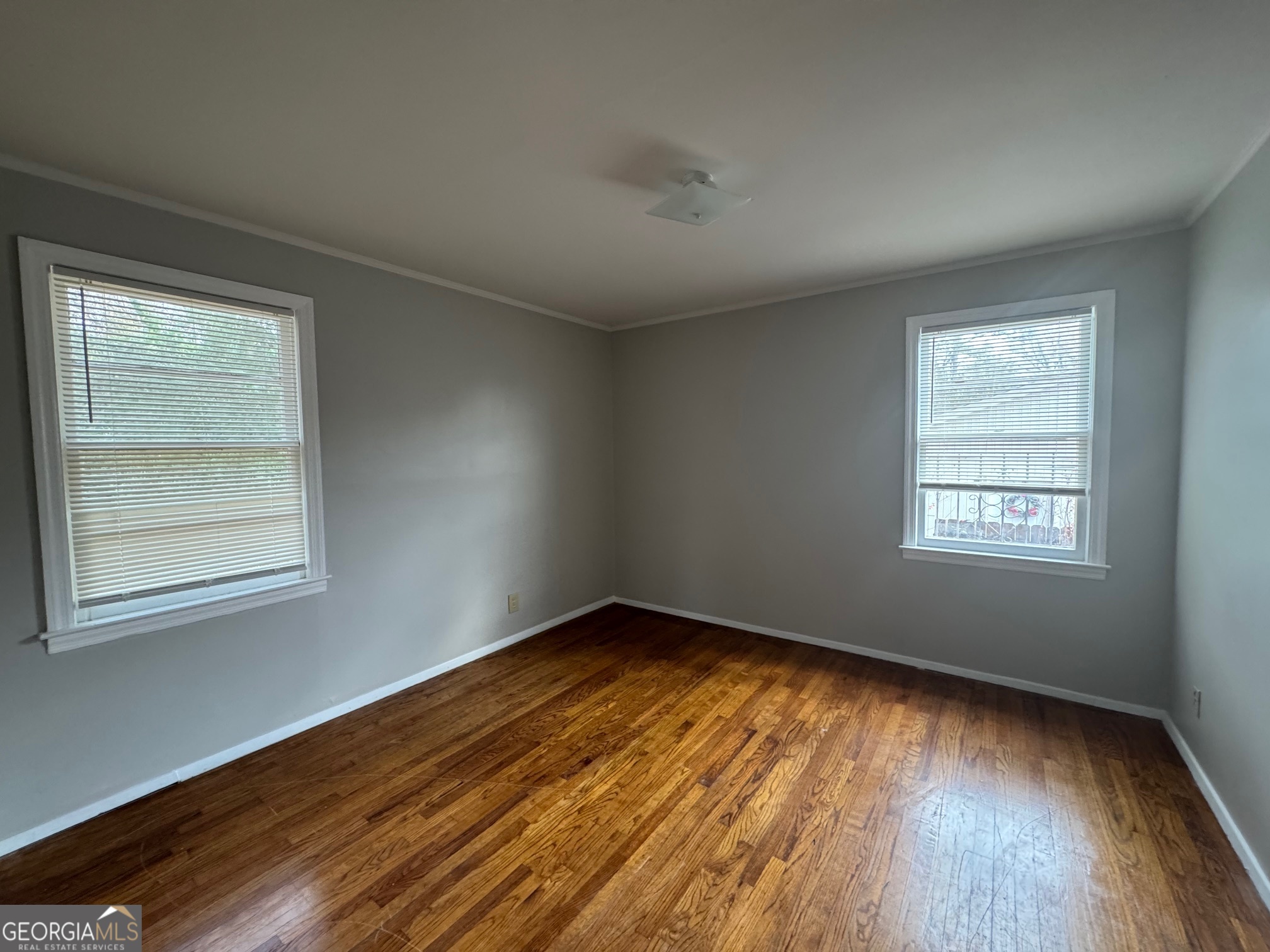 3515 Greenbriar Road Macon, GA 31204 - Photo 9 of 22 an empty room with wooden floor and windows