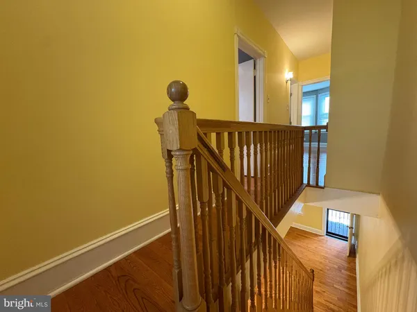 a view of staircase with railing and a window