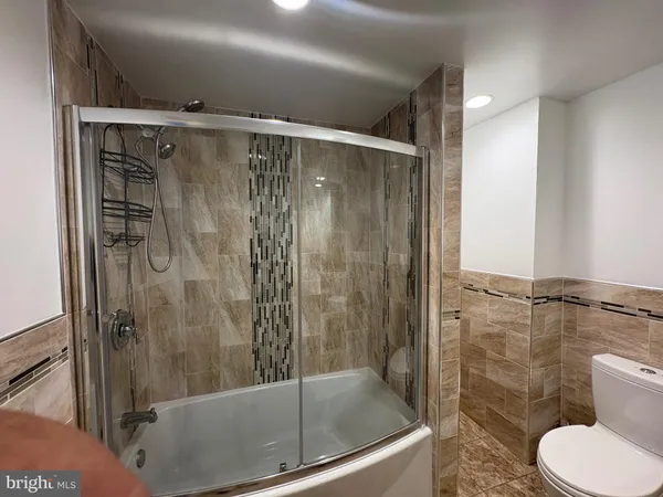 a bathroom with a shower and a toilet