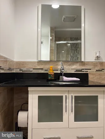 a kitchen with granite countertop a sink and a stove