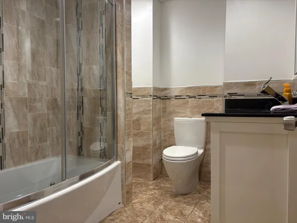 a bathroom with a sink a toilet and bathtub