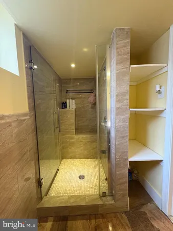 a bathroom with a shower and a mirror