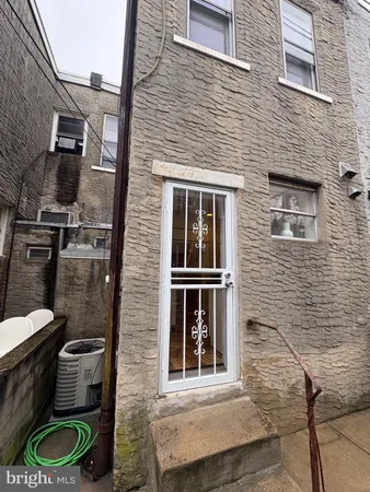 a backyard of a house with barbeque oven