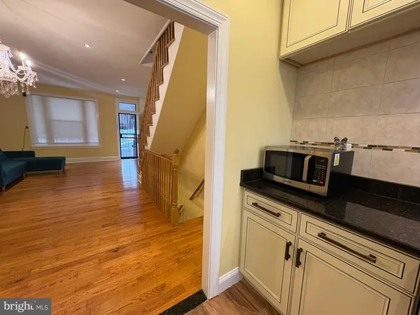 a view of kitchen with stove and refrigerator