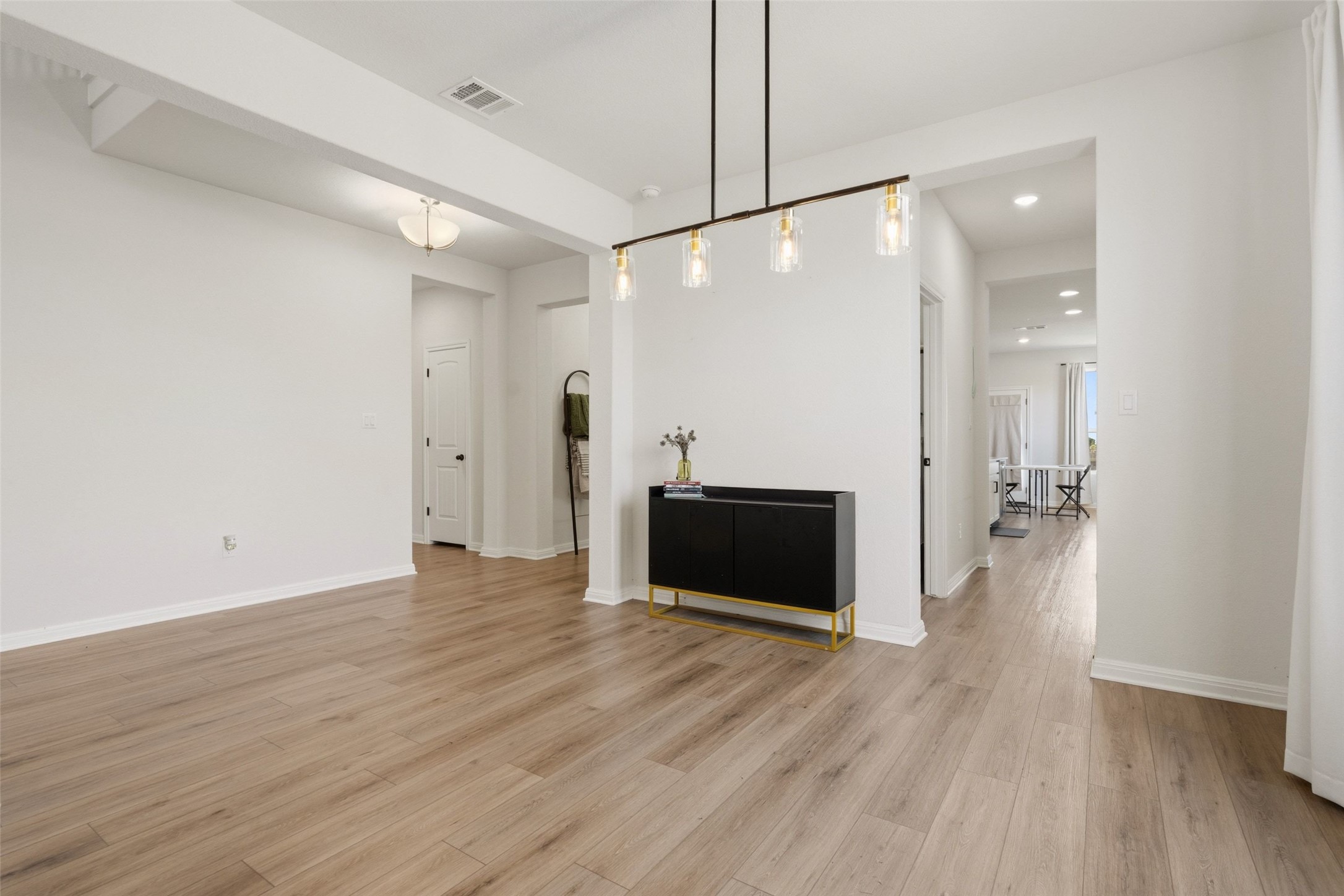 100 Panico Road Hutto, TX 78634 - Photo 15 of 28 Clean lines and light wood-look flooring extend through this open concept interior.