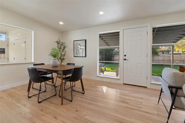 a dining room with furniture and wooden floor