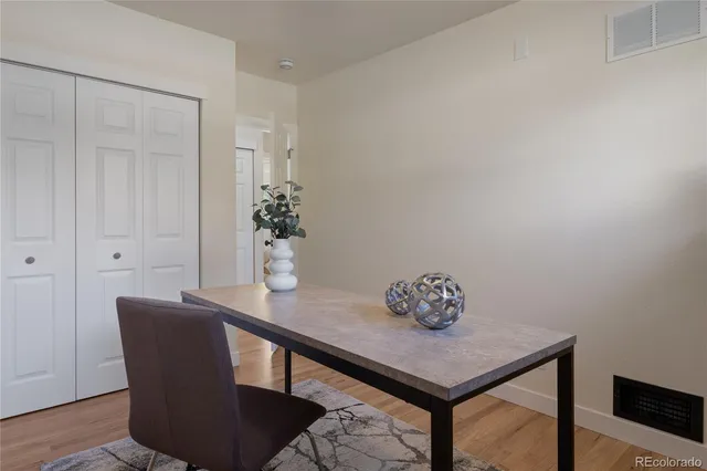 a dining room with furniture and wooden floor