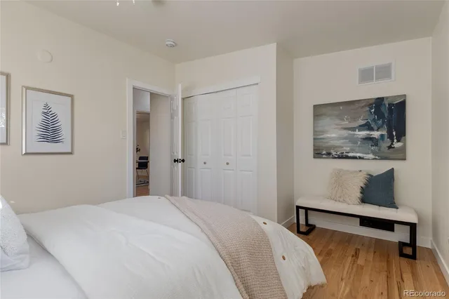 a bedroom with a bed and a wall painting