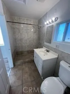 a bathroom with a sink mirror vanity and toilet