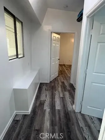 a view of hallway with wooden floor and staircase