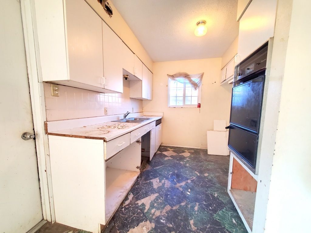 404 Lenore Street Ridgecrest, CA 93555 - Photo 6 of 30 a kitchen with a sink stove and refrigerator