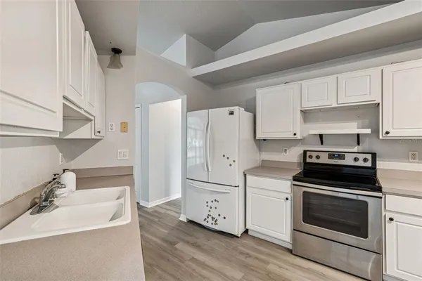 a kitchen with stainless steel appliances white cabinets and a sink
