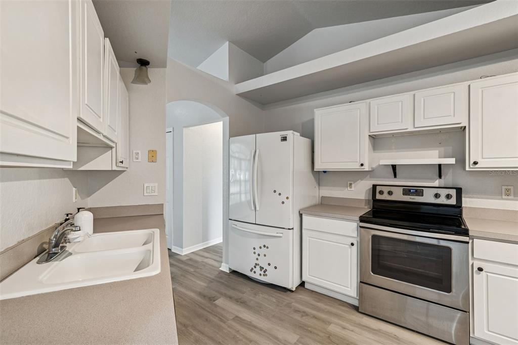 2255 Ancho Avenue Spring Hill, FL 34608 - Photo 16 of 24 a kitchen with stainless steel appliances white cabinets and a sink