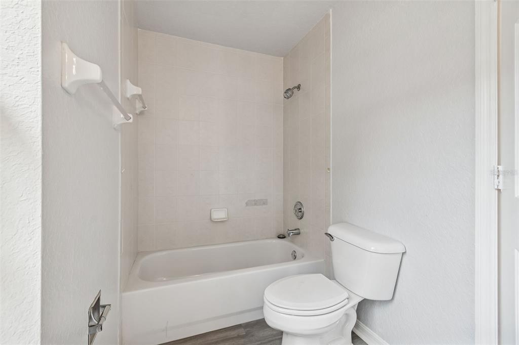 2255 Ancho Avenue Spring Hill, FL 34608 - Photo 18 of 24 a white toilet sitting next to a bath tub