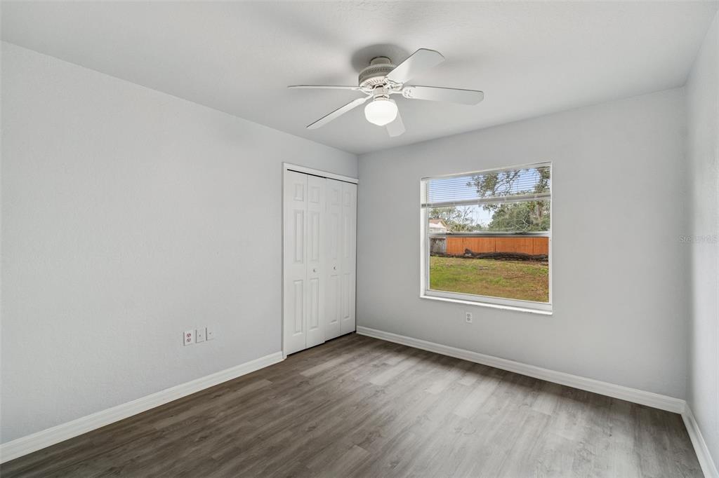2255 Ancho Avenue Spring Hill, FL 34608 - Photo 20 of 24 a view of an empty room with a window and wooden floor