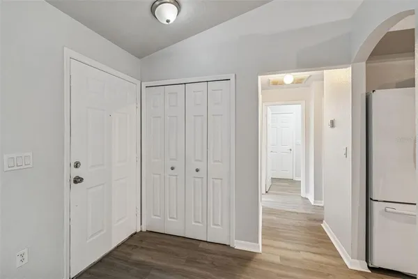 a view of a hallway with wooden floor