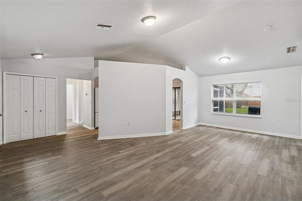 2255 Ancho Avenue Spring Hill, FL 34608 - Photo 5 of 24 a view of an empty room with wooden floor and a window