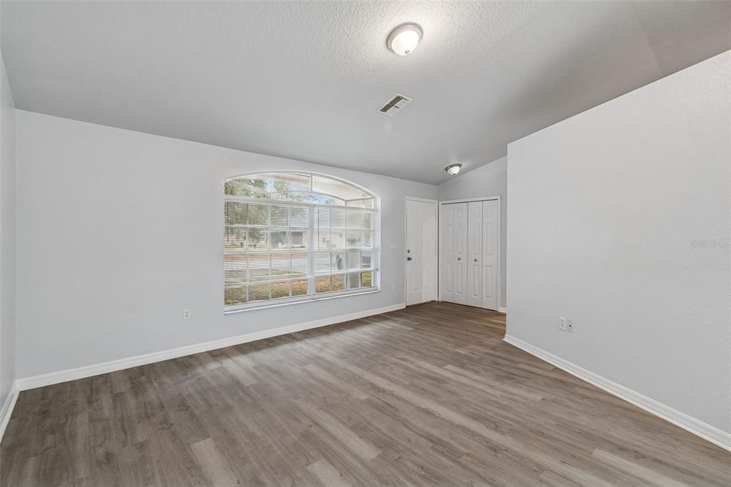2255 Ancho Avenue Spring Hill, FL 34608 - Photo 6 of 24 wooden floor in an empty room with a window
