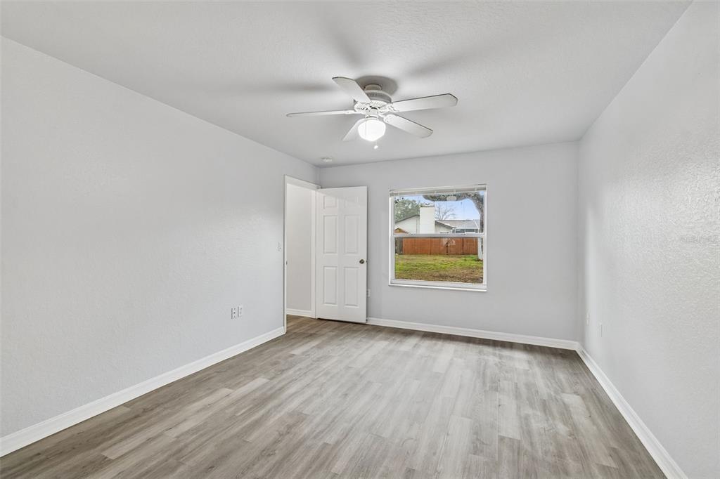 2255 Ancho Avenue Spring Hill, FL 34608 - Photo 9 of 24 wooden floor in an empty room with a window