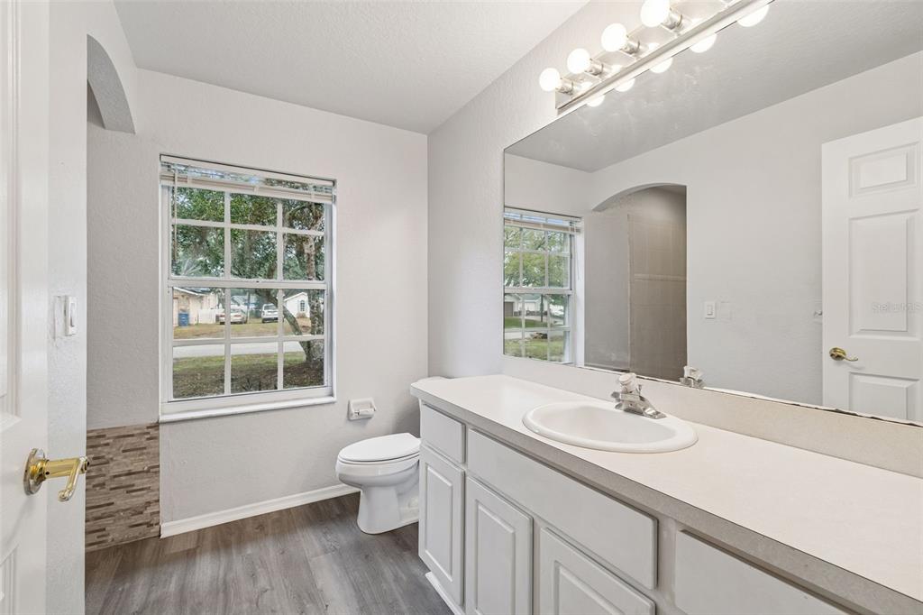 2255 Ancho Avenue Spring Hill, FL 34608 - Photo 10 of 24 a bathroom with a sink a large mirror and a window