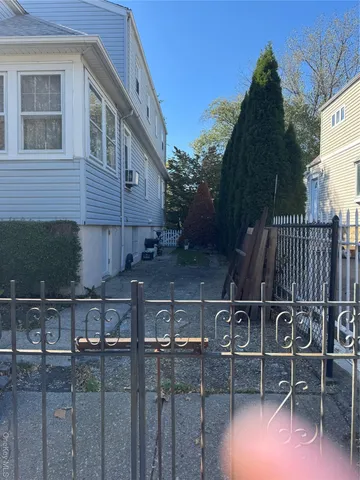 a view of backyard with barbeque grill and wooden fence