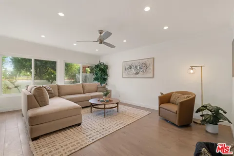 a living room with furniture and a potted plant