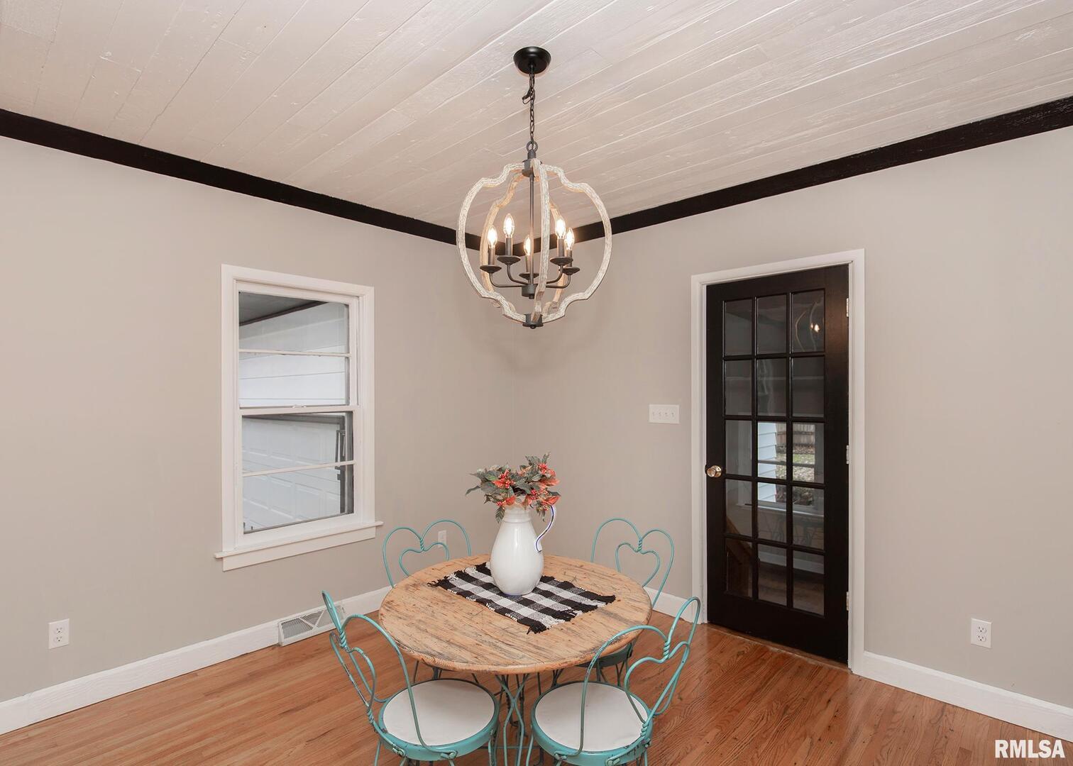 213 North Williams Street Geneseo, IL 61254 - Photo 14 of 42 a view of a dining room with furniture wooden floor and chandelier